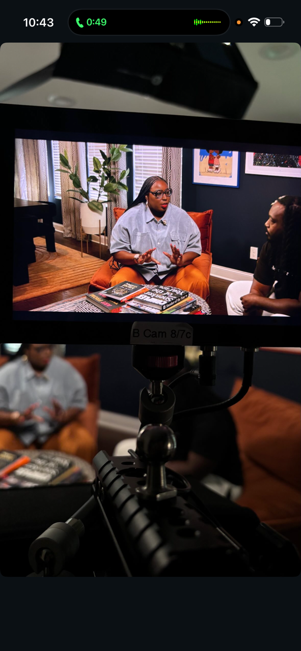 Director's monitor: Madam Prezident in conversation, orange velvet, books on the table